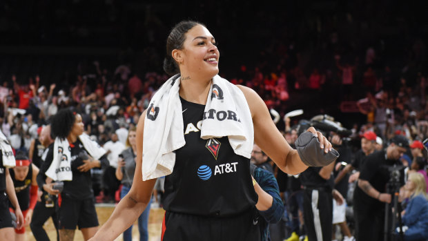 Liz Cambage throws t-shirts into the crowd after helping to keep Las Vegas' season alive.