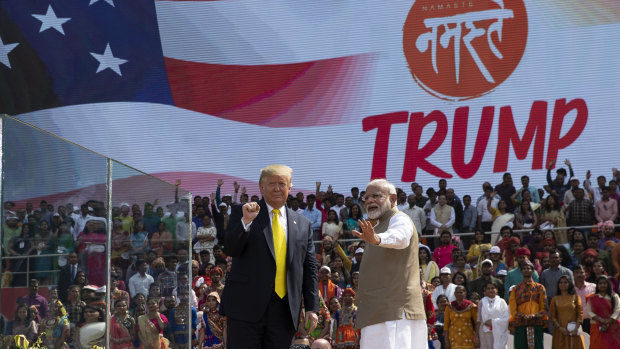 US President Donald Trump and Indian Prime Minister Narendra Modi wave after a "Namaste Trump" event at Sardar Patel Gujarat Stadium.