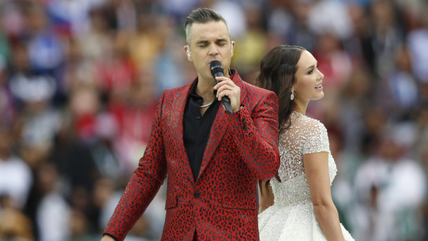 Duet: Robbie Williams and Aida Garifullina sing prior to the opening match. 