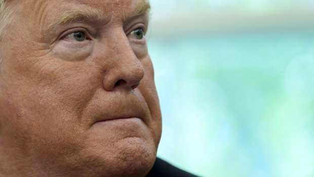 President Donald Trump listens in the Oval Office on Wednesday.