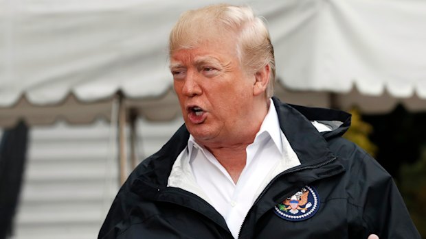 President Donald Trump answers questions  as he leaves the White House on Saturday to see fire damage in California. 