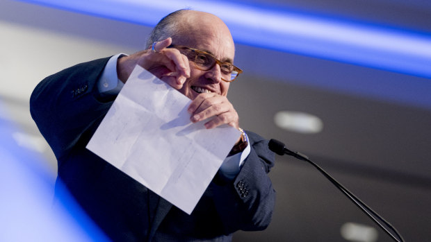 Donald Trump's lawyer Rudy Giuliani pretends to tear a piece of paper as he speaks about the Iran nuclear agreement at a Washington hotel in May.