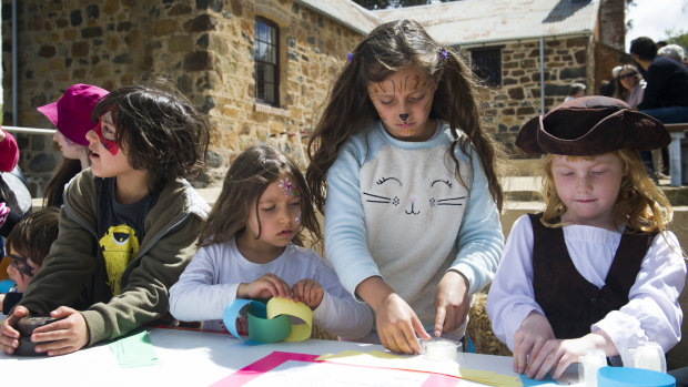 Darius, 7, Yasmin, 5 and Aaliyah Nanva, 9, and Elizabeth Parton, 5, take part in creating a paper chain at the Blundell's Cottage Gala Day.