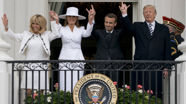 Melania Trump embraced her moment in the spotlight, ditching her trademark dark sunglasses and shining in a look-at-me white skirt suit and matching hat.