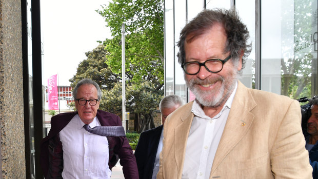 Theatre director Neil Armfield, right, leaves the Federal Court on Wednesday with Geoffrey Rush.