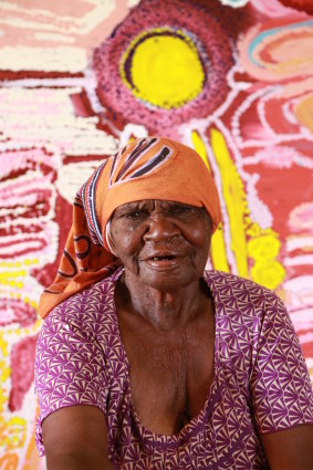 Jakayu Biljabu of Martumili Artists East Pilbara Art Centre in front  of her work, Wilkiri, 2014.