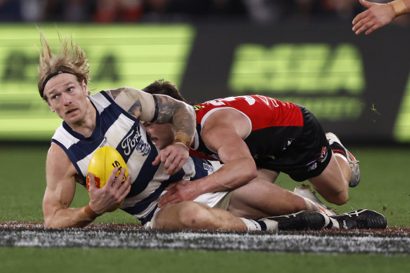 Jack Sinclair of the Saints tackles Tom Stewart of the Cats.