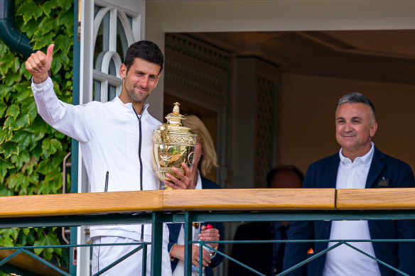 Novak Djokovic and his father celebrate his Wimbledon win in 2019.