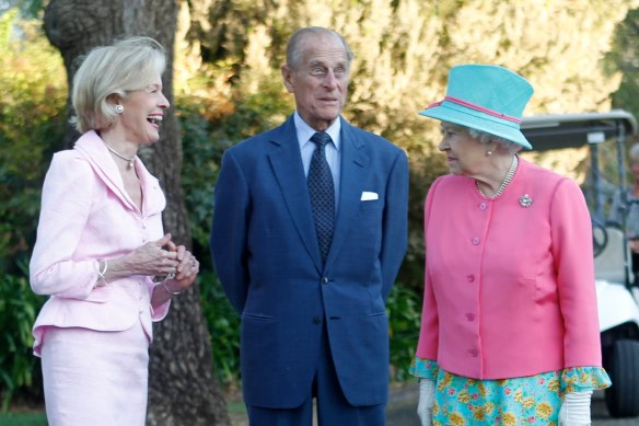 The Queen talks to governor-general Quentin Bryce and Prince Philip after she toured the Government House gardens in Canberra and planted a tree, in October 2011.