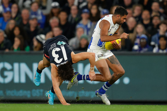 North’s Tarryn Thomas gets away from Carlton’s Liam Stocker.