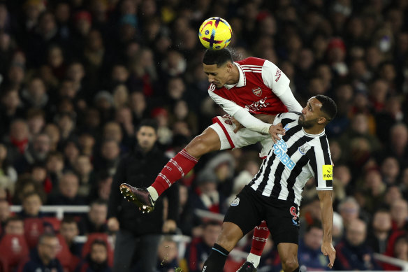 Arsenal’s William Saliba duels for the ball with Callum Wilson