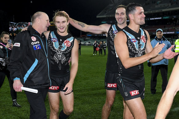 Port Adelaide coach Ken Hinkley with his players after a win.