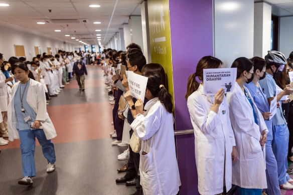 Medical workers hold signs during a protest organised by the medical sector at Queen Mary Hospital in Hong Kong, in September.