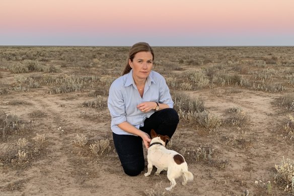 Alison McLean and her dog Gary in a paddock on her drought-stricken sheep farm north of Hay. “If we can see the turbines, we want to feel it in our hip pocket,” she says.