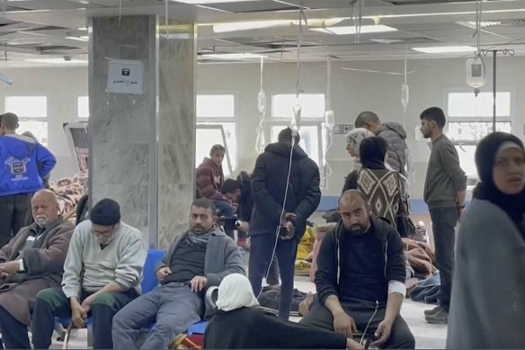 Injured people sit inside al-Shifa Hospital on Thursday in Gaza City.