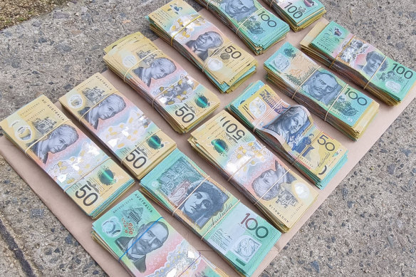 Cash allegedly seized during raids on Wednesday in which three people were charged. 