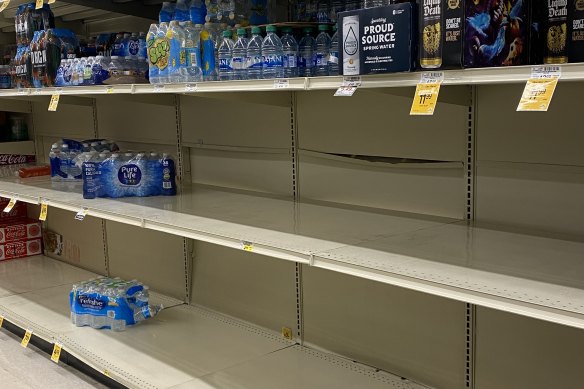 Water, water everywhere, but not a drop to drink ... locals in Los Angeles panic buy essential goods.