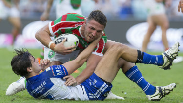 Absorbing battle: Bulldogs half Lachlan Lewis locks horns with Souths skipper Sam Burgess.