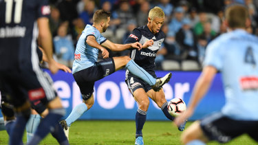 Revved up: Sydney's Michael Zullo blocks a cross from Victory's Keisuke Honda.