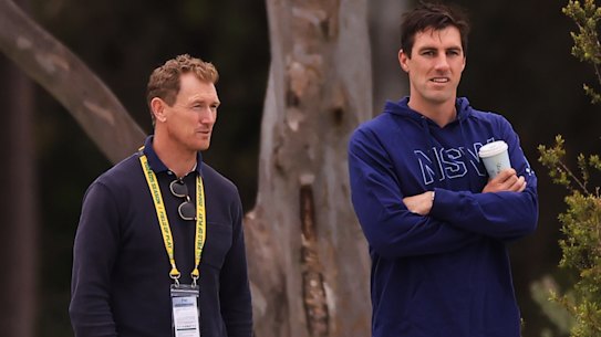 Chief selector George Bailey watches a Shield match alongside Pat Cummins.