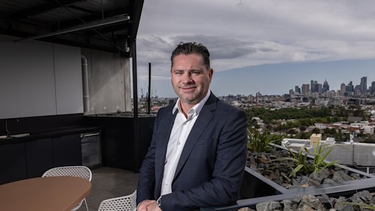 Salta Properties Managing Director Sam Tarascio stands on the balcony of Fitzroy and Co, the company’s pilot build-to-rent project.