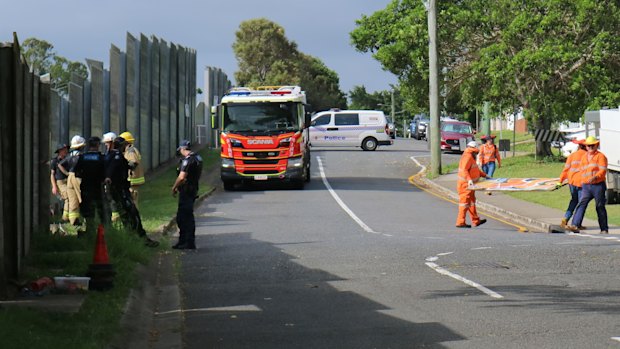 Emergency services at the scene of a crash near Wooloowin train station in northern Brisbane, where a car crashed through a fence and onto the railway line. December 16, 2025.