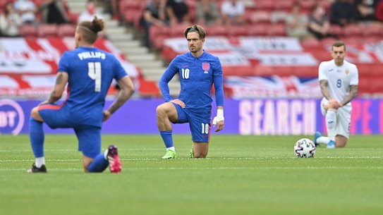 England’s Jack Grealish takes a knee before the international friendly soccer match between England and Romania.