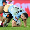 James Tedesco’s shorts fall down as Cameron Munster looks on.