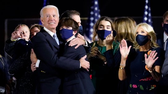 President-elect Joe Biden and Jill Biden stand with their family and watch fireworks