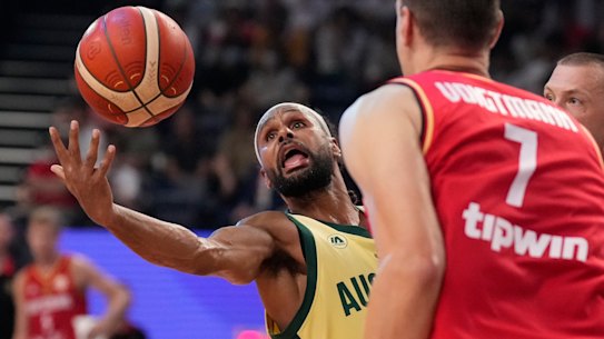 Patty Mills battles German centre Johannes Voigtmann.
