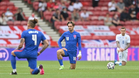 England’s Jack Grealish takes a knee before the international friendly soccer match between England and Romania.