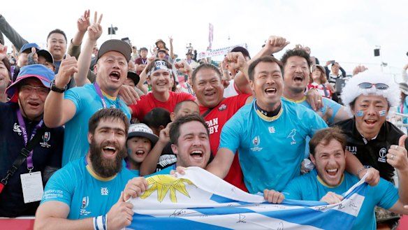 Triumphant Uruguayan players celebrate with the crowd after their stunning defeat of Fiji.