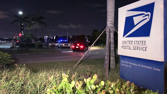 Postal service police screen employees entering the Royal Palm processing and Distribution Centre in Opa-locka, Florida. 