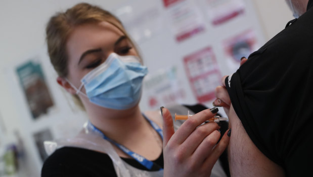 A third round of vaccines: a pharmacy technician administers a dose of the AstraZeneca COVID-19 vaccine at the Wheatfield surgery in Luton, England. 