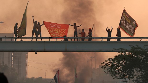 Anti-government protesters chant slogans during a protest in Baghdad, Iraq.