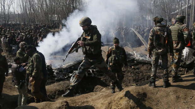 Indian army soldiers arrive near the wreckage of an Indian aircraft after it crashed in Budgam area, outskirts of Srinagar, Indian controlled Kashmir.