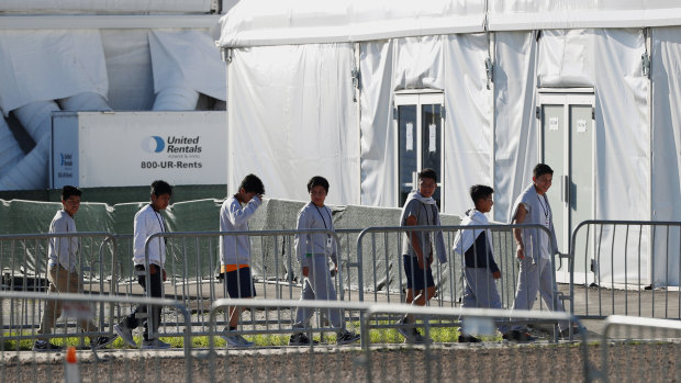 Children line up to enter a tent at the Homestead Temporary Shelter for Unaccompanied Children in Homestead, Florida. 