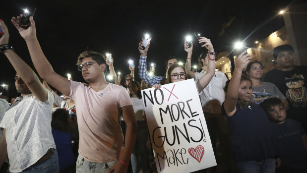 People gather in Juarez, Mexico, in a vigil for the three Mexican nationals who were killed in an El Paso shopping complex shooting. 