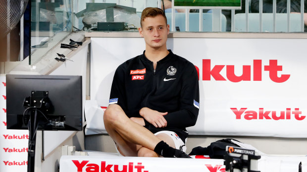 Nathan Kreuger looks on from the bench after being subbed out of the Anzac Day game at the MCG.