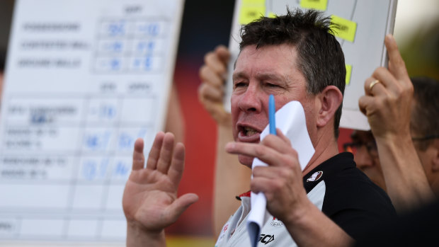 Saints coach Brett Ratten speaks to his players at quarter-time against Fremantle on Saturday.