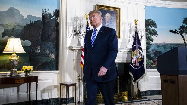 Donald Trump exits after speaking about the US exit from the Iran deal.