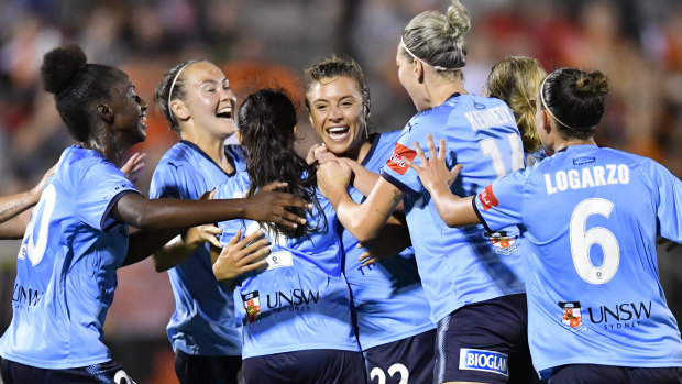 Triumphant: Sofia Huerta is mobbed after scoring the winner for Sydney FC.