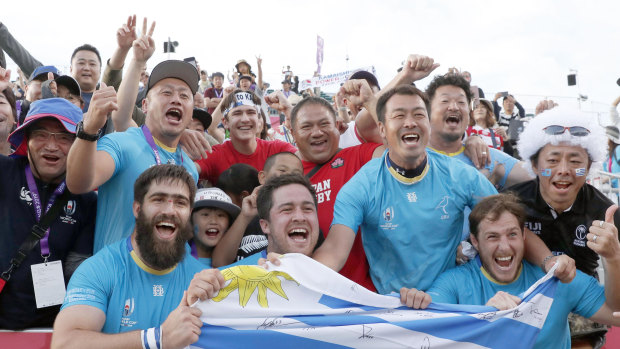 Triumphant Uruguayan players celebrate with the crowd after their stunning defeat of Fiji.