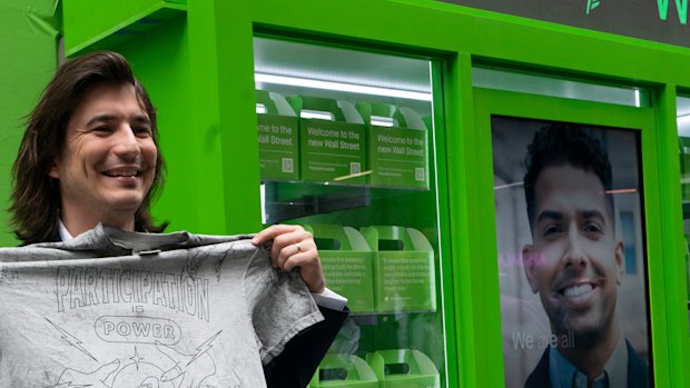 Vladimir Tenev, CEO and co-founder of Robinhood, holds a T-shirt that reads “Participation is Power” following his company’s IPO last week. 