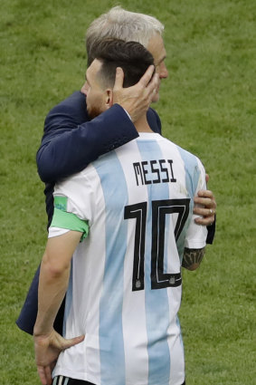 Lionel Messi is comforted by France head coach Didier Deschamps.