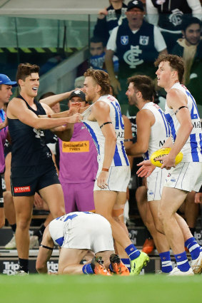 Lewis Young and Hugh Greenwood wrestle as Cameron Zurhaar lies on the ground.