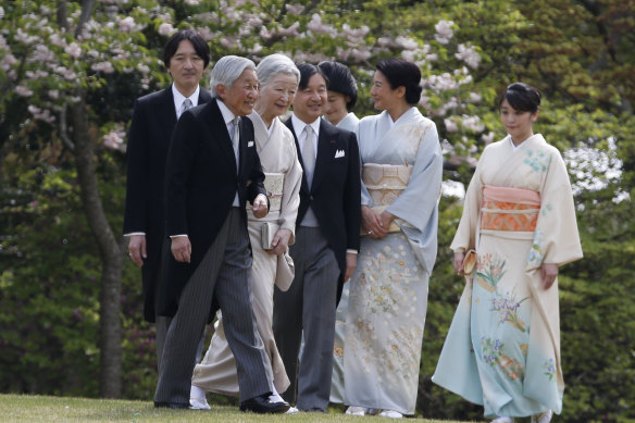 Former emperor Akihito, second from left, with Michiko, third from left,  Naruhito, fourth from left, Masako, second from right, Prince Akishino, Princess Kiko, third from right, and their daughter Princess Mako at a palace garden party in Tokyo in 2017. 