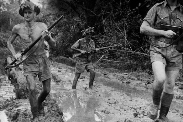 Australian troops plough through the mud at Milne Bay after repulsing the Japanese invasion attempt.