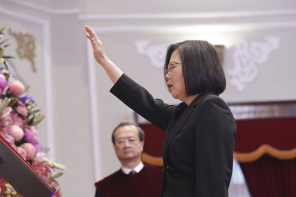 Taiwanese President Tsai Ing-wen raises her hand during an inauguration ceremony at the Presidential office in Taipei on Wednesday.