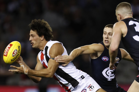 Ben Long gets the ball away for the Saints at Marvel Stadium in the AFL’s first Community Series match on Thursday night.